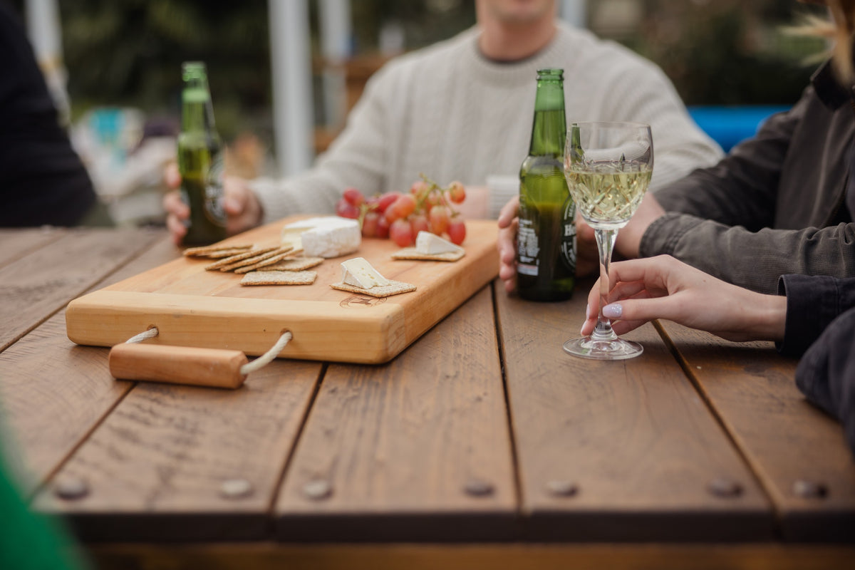 Food and wine on a macrocarpa woolpress leaner
