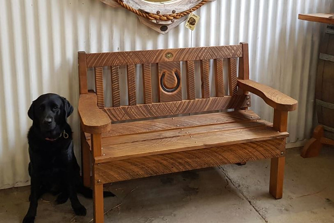 1.2m garden seat with horse shoe cutout in a garden setting