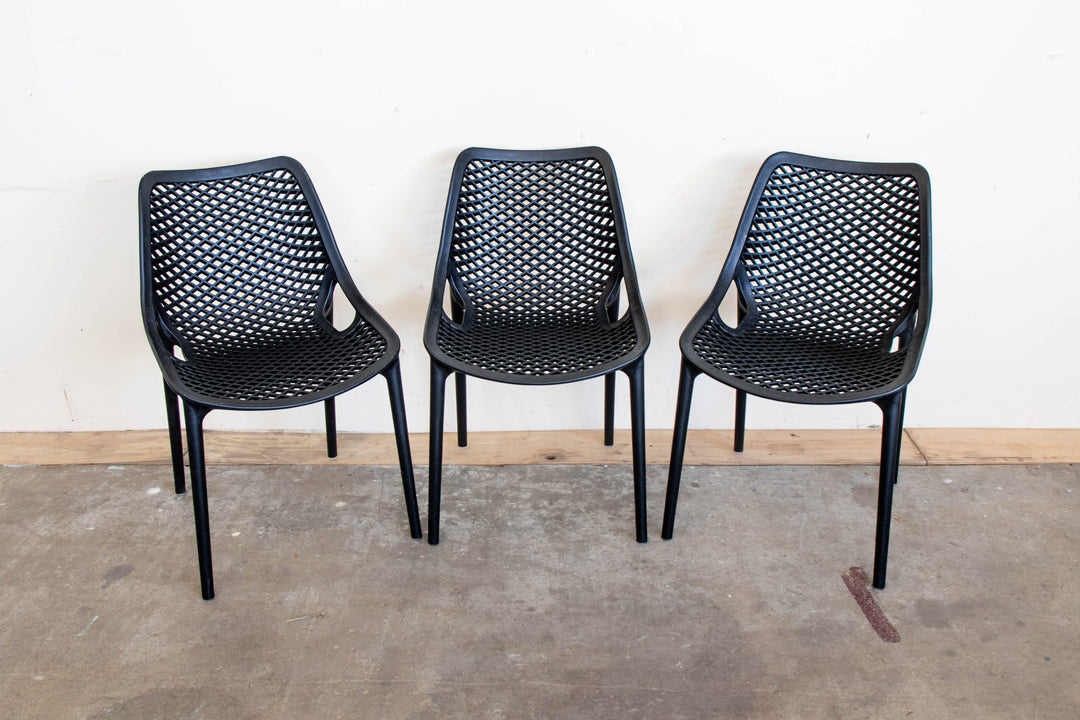 Three Black Bean resin chairs in black