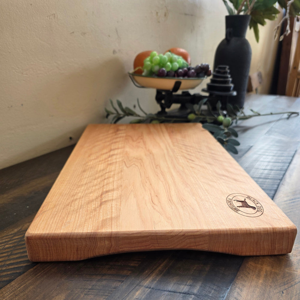 Long macrocarpa serving board on a rustic table