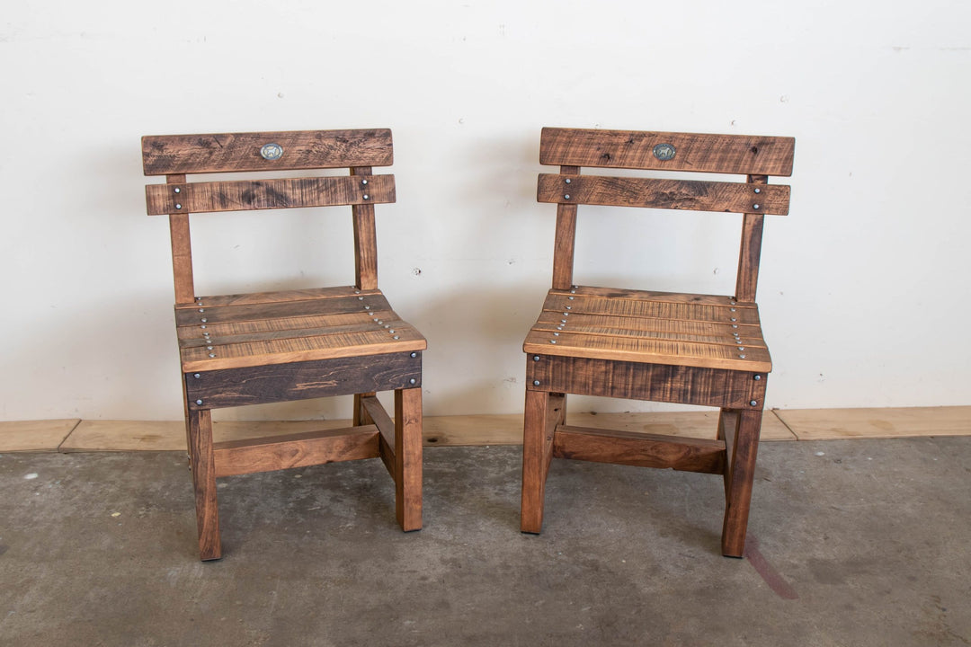 A pair of macrocarpa outdoor pew chairs