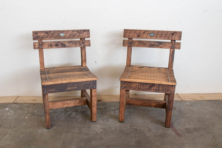 A pair of macrocarpa outdoor pew chairs