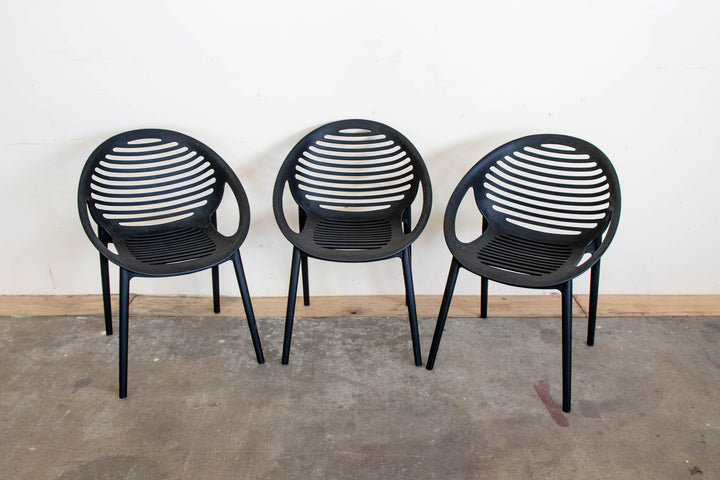 Three Round Yeti resin chairs in black